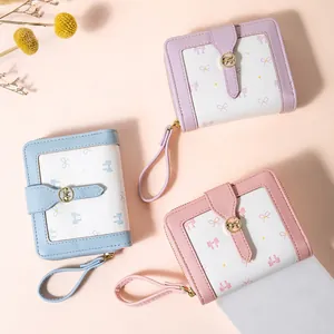 Three elegant bow print PU leather short zip wallets in pink, blue, and purple tones