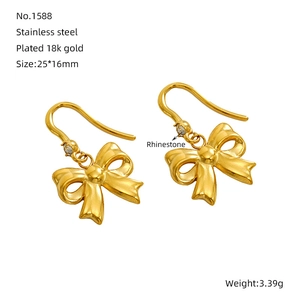 Detailed view of 18k gold plated bow earrings in stainless steel with rhinestone