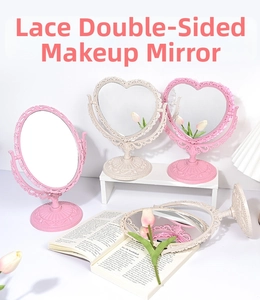 Close-up of European style embossed heart and oval vanity mirrors with rotatable stands