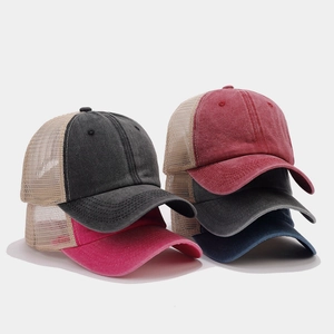 Detailed stack of vintage mesh baseball caps in multiple colors with washed cotton texture