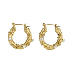 Detail of 18k gold plated hoop earrings with irregular lava texture and white pearls