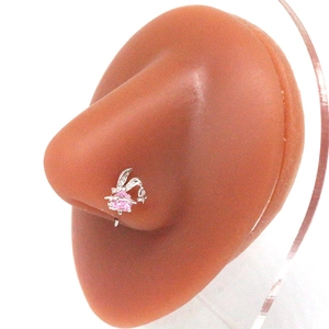 Macro view of silver rabbit nose ring with pink heart gem on silicone model