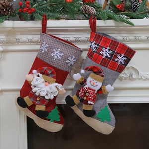 Christmas stockings set with 3D Santa and snowman hanging on a festive fireplace mantel