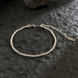 Detail of shimmering 18K gold plated titanium steel chain with lobster clasp and extender