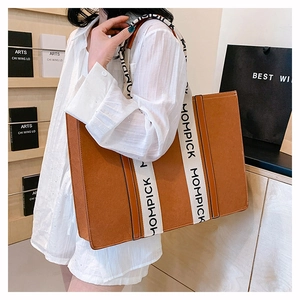 Detail of large brown felt tote bag featuring contrast MOMPICK logo straps for women