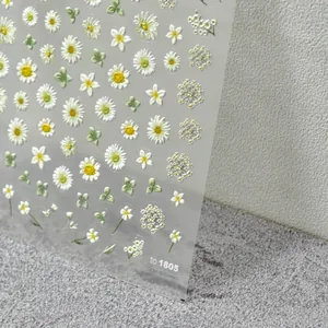 Detail of 3D embossed sunflower and daisy nail stickers with delicate relief texture