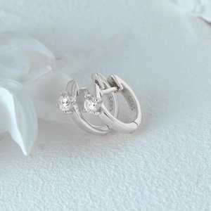 Detailed close-up of S925 sterling silver huggie earrings with double-row crystals