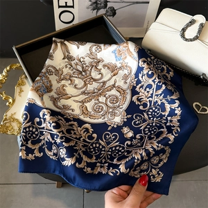 Elegant navy and gold baroque floral silk square scarf displayed with fashion accessories