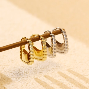 Detailed view of S925 sterling silver handbag-shaped earrings in gold and silver finish