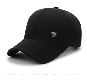 Detailed side view of black baseball cap featuring silver metallic shield emblem ornament