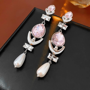 Detail of teardrop pearl earrings with pink pear-shaped crystal and cubic zirconia