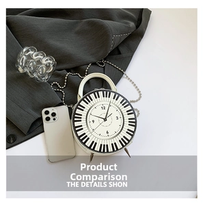 Detail view of round crossbody bag with piano keyboard clock face design and chain strap