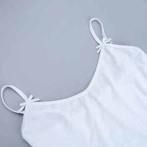 Detail of white slim-fit camisole top featuring a delicate bow and soft fabric texture