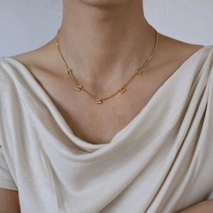 Elegant gold titanium steel necklace featuring five delicate cherry pendants on a thin chain