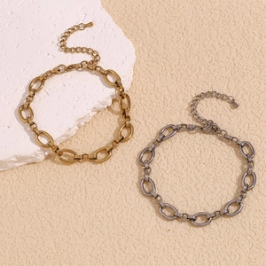 Detail of 14K gold and silver chunky oval link anklets with lobster clasp on stone