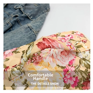 Close-up of quilted floral makeup bag featuring soft cotton fabric and padded handle grip