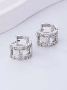 Close-up of geometric H-shaped silver earrings with micro-set pave crystals