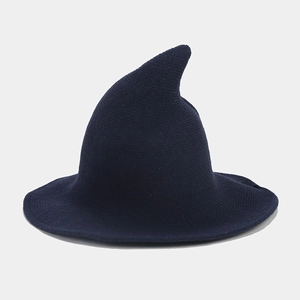 Detail of navy blue knitted witch hat showing high-density yarn texture and pointed top