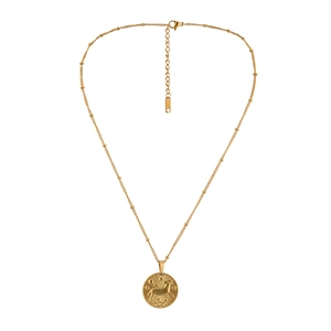 Macro shot of gold stainless steel coin pendant with Aries motif and bead chain clasp