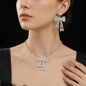 Sparkling silver bow jewelry set with crystal necklace and earrings on a model