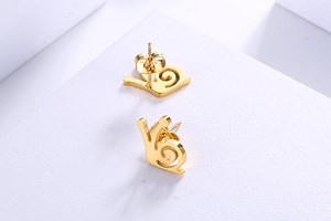 Detailansicht der goldenen Schnecken-Ohrstecker aus hochwertigem Titanstahl