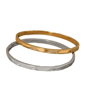 Elegant wave-shaped stainless steel bangles set in gold and silver with cubic zirconia