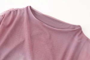 Detail view of the purple mesh fabric featuring a round neck and pleated shoulder texture
