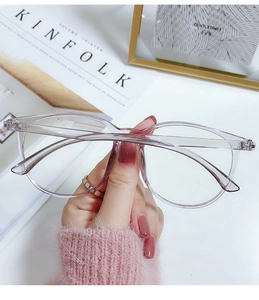 Close-up of transparent pink large round frame glasses with blue light blocking lenses