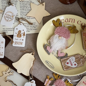 Flat lay of Christmas wooden ornaments with snowman and reindeer on vintage paper