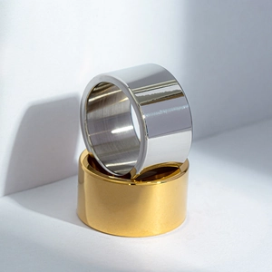 Close-up of 12mm wide polished gold and silver titanium steel rings for men