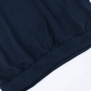 Detailed close-up of the ribbed hem and stitching on a dark blue casual sweatshirt