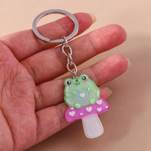 Cute green frog sitting on pink mushroom acrylic keychain with metal heart charm