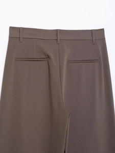 Detail view of dark brown suit trousers featuring belt loops and two rear welt pockets