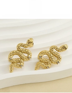 Detailed view of 18K gold plated snake stud earrings with scales and zircon stones