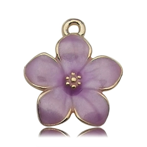 Detail of flower charm with golden metal frame and purple enamel for DIY jewelry making