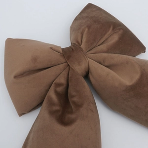 Close-up of a mocha velvet decorative bow showing detailed fabric texture and sheen