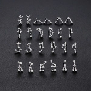 Macro display of twelve sterling silver zodiac stud earrings with sparkling cubic zirconia