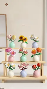 Detailed view of nine assorted building block flowers in mini vases on a wooden display stand
