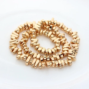 Macro view of golden irregular electroplated hematite spacer beads for jewelry DIY
