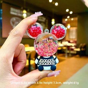 Detailed size view of glowing Mickey mouse keychain with red liquid and star sequins