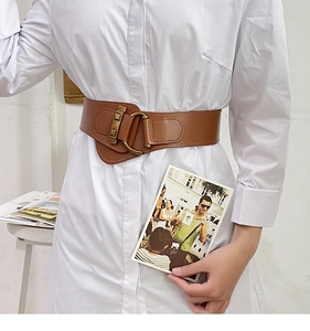 Brown wide leather cinch belt with golden buckles styled over a long white shirt