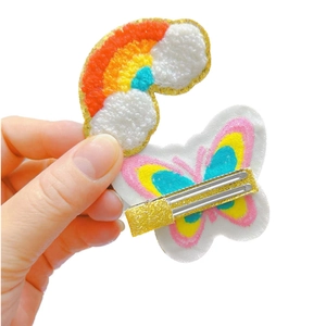 Cute plush embroidered rainbow and butterfly hair clips for girls shown on white background