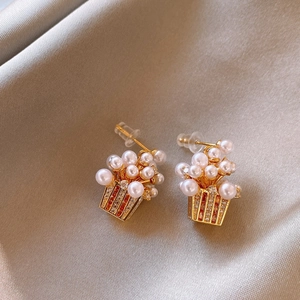 Detail shot of 18K gold plated popcorn earrings with pearls and amber zircon accents