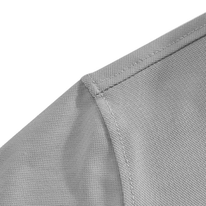 Macro shot of grey quick-dry polo shirt showing honeycomb mesh fabric and neat shoulder stitching