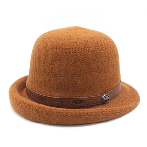 Caramel knit cloche hat with a decorative brown embossed leather band and vintage buckle
