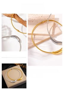 Macro view of minimalist polished metal pendant with detailed rope chain in gold and silver