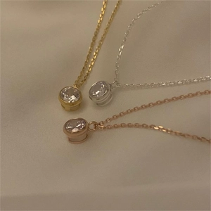 Macro detail of 925 sterling silver necklaces in gold, silver, and rose gold with zircon