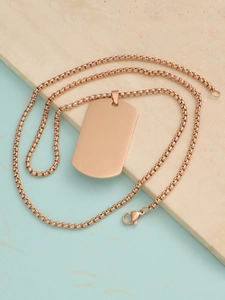 Macro detail of rose gold rectangular dog tag pendant on a round box chain necklace