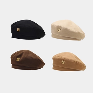 Set of four cotton beret hats in black, beige, brown, and camel with gold metal C tag