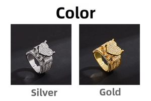 Close-up of gold and silver heart-shaped iced out rings with micro zircon pavé setting